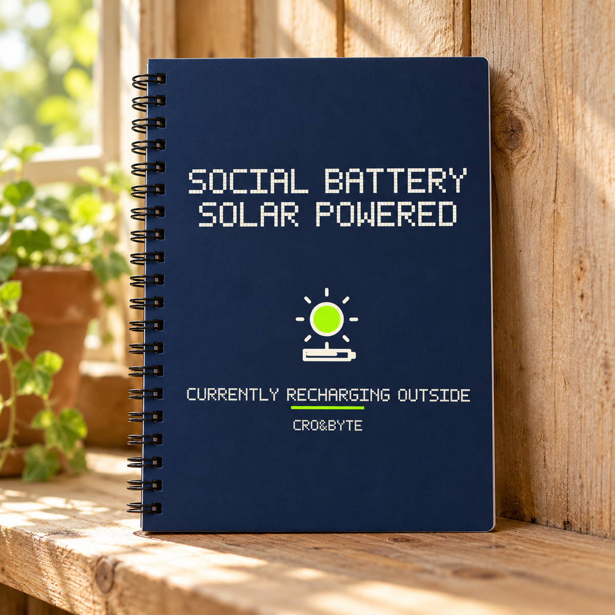 Social Battery Solar Powered — Navy notebook, individual realistic product photograph