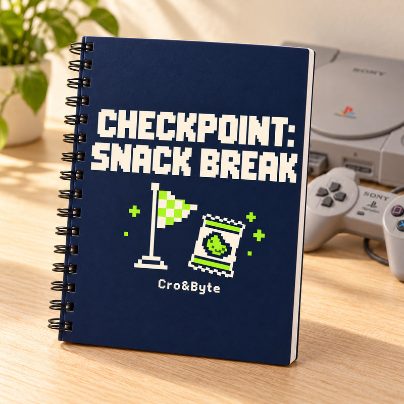 Checkpoint: Snack Break — Notebook — styled product photo with matching original PlayStation console and controller
