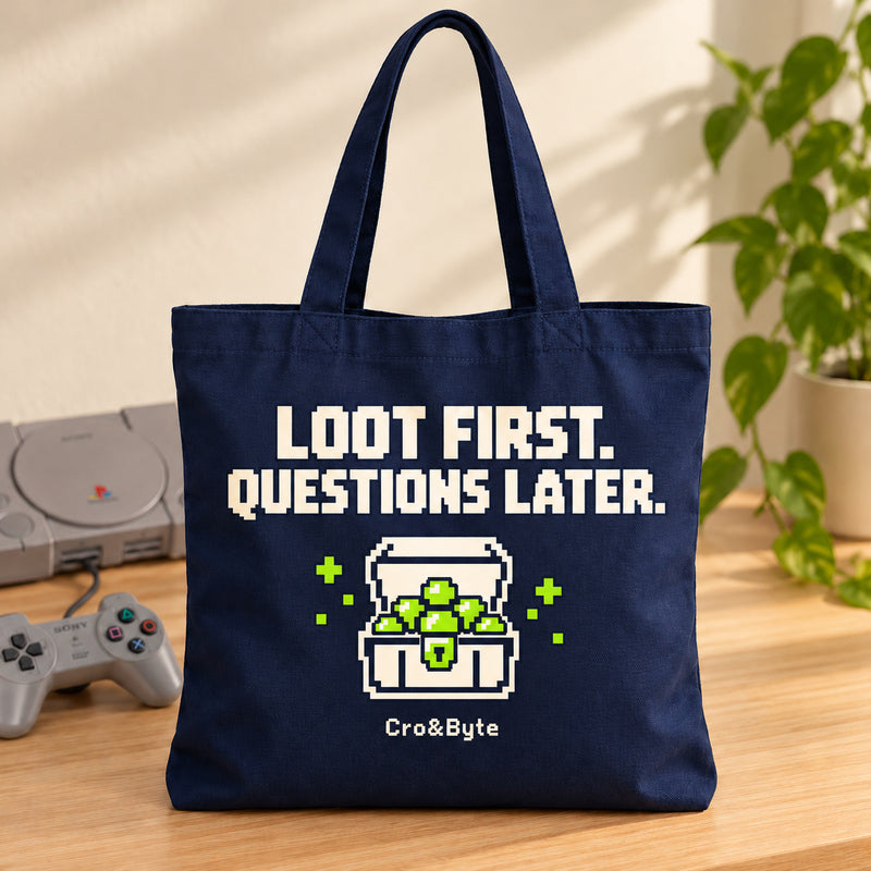 Loot First. Questions Later. — Tote Bag — styled product photo with matching original PlayStation console and controller