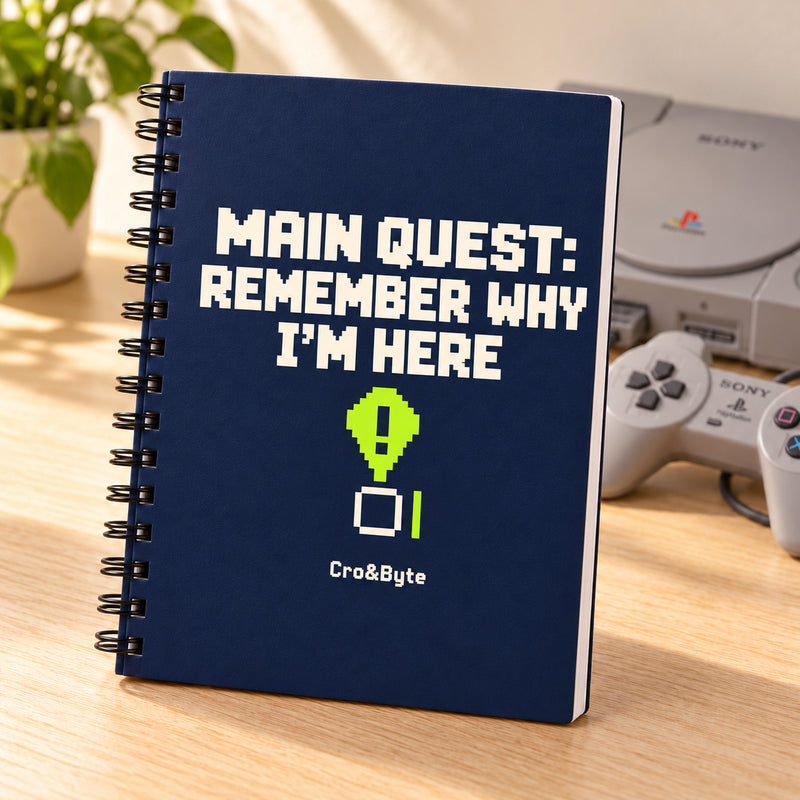 Main Quest: Remember Why I’m Here — Notebook — styled product photo with matching original PlayStation console and controller