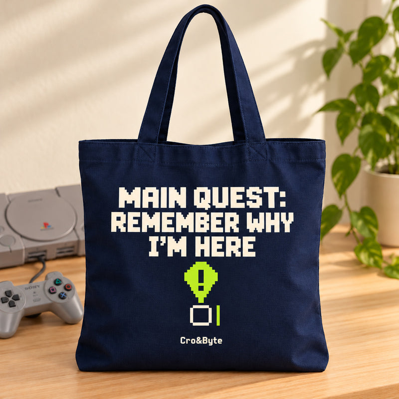 Main Quest: Remember Why I’m Here — Tote Bag — styled product photo with matching original PlayStation console and controller