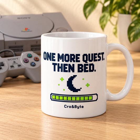 One More Quest. Then Bed. — Mug — styled product photo with matching original PlayStation console and controller