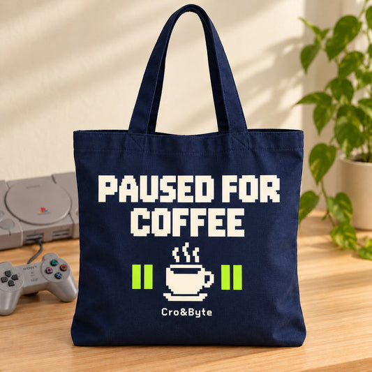 Paused for Coffee — Tote Bag — styled product photo with matching original PlayStation console and controller